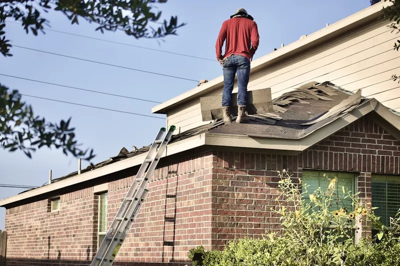 Professional roofer working on a residential roof in Sodom